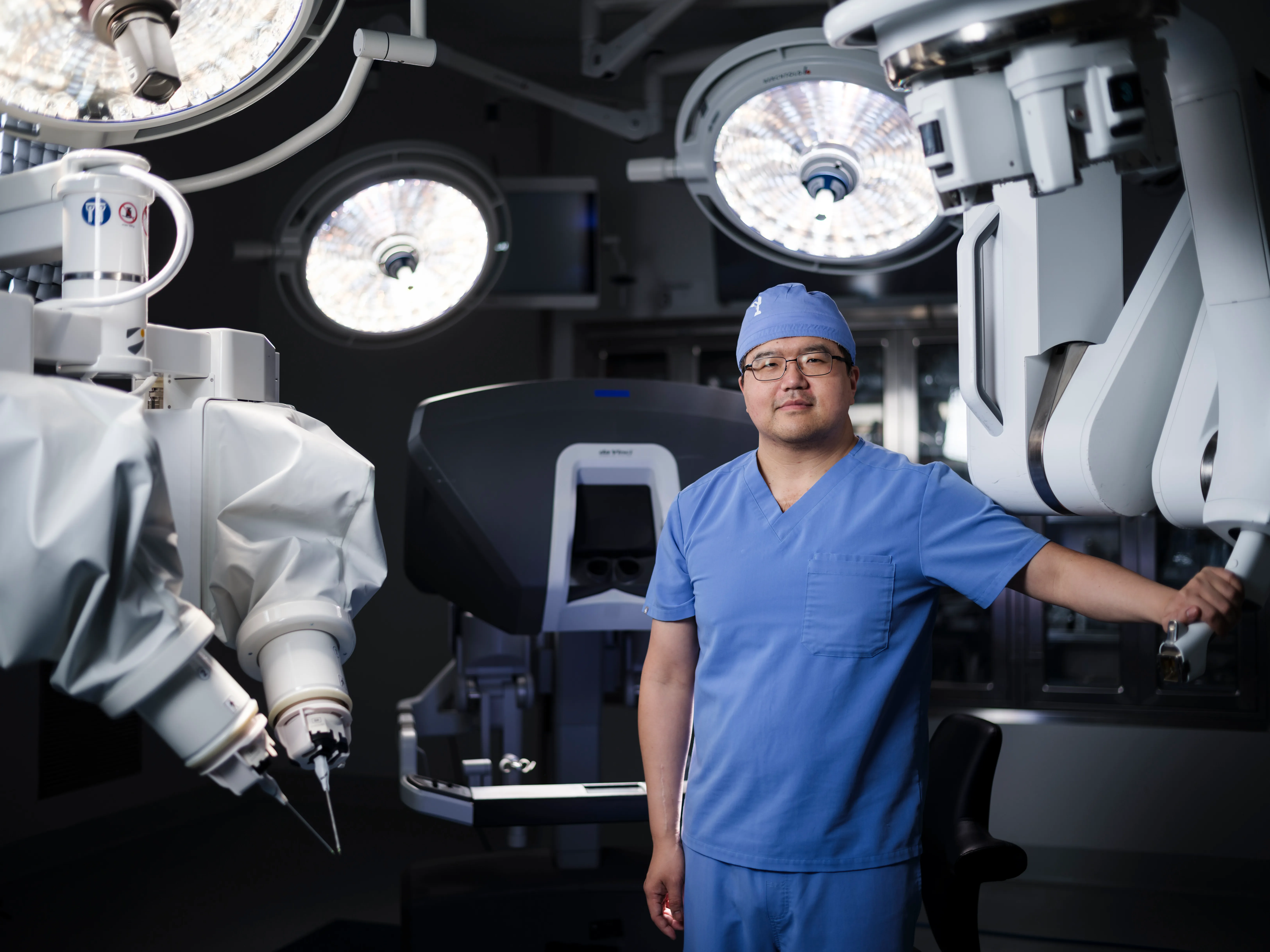 Lee C. Zhao, MD, in the operating room between robotic surgical systems